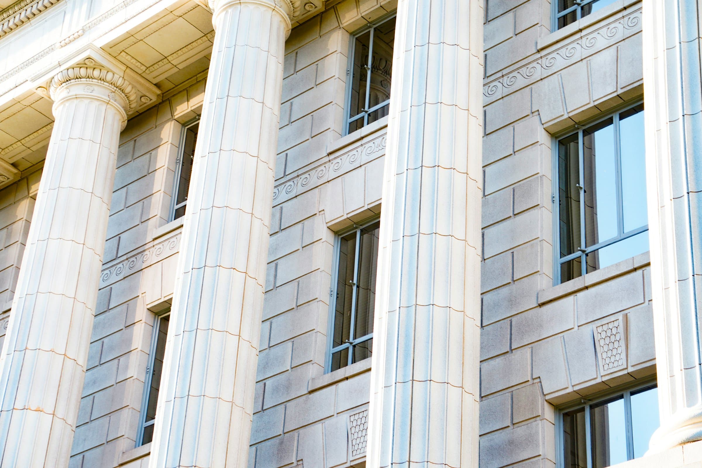 Stone columns and windows on the facade of a neoclassical federal government building